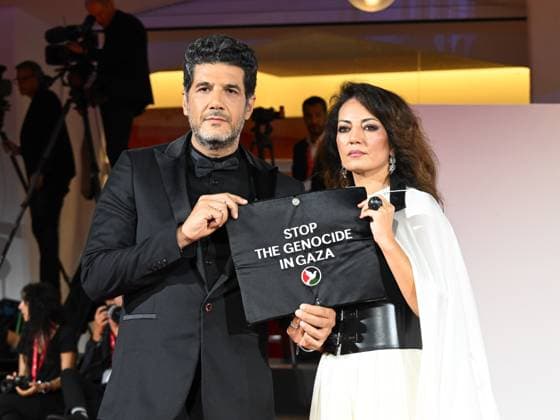 Venice, 82nd Venice International Film Festival 2025 - Evening 3 - The Red Carpet for the film Calle Malaga. Pictured: Stop the Genocide in Gaza: Nabil Ayouch, Maryam Touzani  Copyright: xManuelexMangiarottix xipa-agency.netx xPoolxPhotoxEventsx06x IPA_Agency_IPA63587616