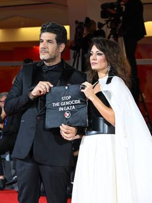 Venice, Italy: Venice, 82nd Venice International Film Festival 2025 - Evening 3 - The Red Carpet for the film Calle Malaga. Pictured: Stop the Genocide in Gaza: Nabil Ayouch, Maryam Touzani Venice Italy  - ZUMAp169 20250829_zea_p169_1360 Copyright: xManuelexMangiarottix