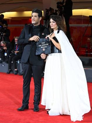Venice, 82nd Venice International Film Festival 2025 - Evening 3 - The Red Carpet for the film Calle Malaga. Pictured: Stop the Genocide in Gaza: Nabil Ayouch, Maryam Touzani  Copyright: xManuelexMangiarottix xipa-agency.netx xPoolxPhotoxEventsx06x IPA_Agency_IPA63587602