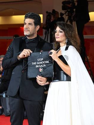 Venice, 82nd Venice International Film Festival 2025 - Evening 3 - The Red Carpet for the film Calle Malaga. Pictured: Stop the Genocide in Gaza: Nabil Ayouch, Maryam Touzani  Copyright: xManuelexMangiarottix xipa-agency.netx xPoolxPhotoxEventsx06x IPA_Agency_IPA63587603