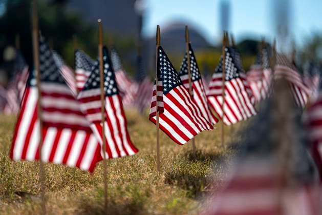 American flags are placed in the grass outside the Department of Labor headquarters during Labor Day weekend in Washington, DC on Saturday, August 30, 2025.  WAP20250830322 BONNIExCASH