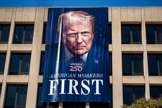 A portrait of President Donald Trump is draped on the front of the Department of Labor Headquarters in Washington, DC on Saturday, August 30, 2025. The banner, displayed next to a portrait of Teddy Roosevelt, features Trump s second inaugural portrait, the logo for his America 250 initiative, and the words American Workers First.  WAP20250830324 BONNIExCASH