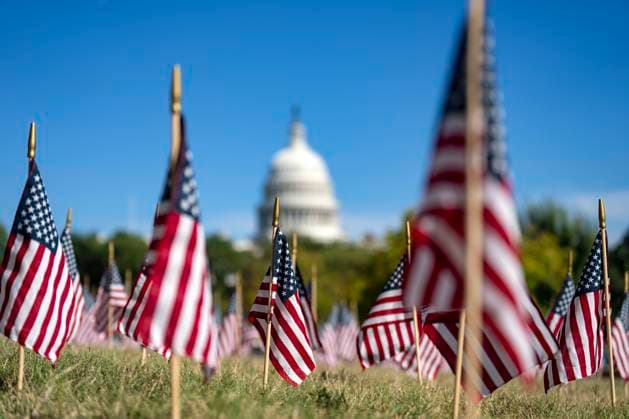 American flags are placed in the grass outside the Department of Labor headquarters near the U.S. Capitol building during Labor Day weekend in Washington, DC on Saturday, August 30, 2025.  WAP20250830329 BONNIExCASH