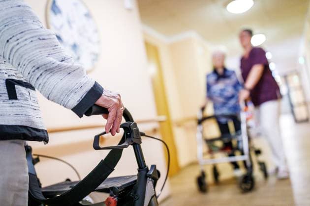 Symbol photo nursing home DEU Germany illustration, 29 08 2025, symbol photo elderly care nursing professions, senior citizens with rollator and a caregiver can be seen in a corridor in a nursing home in Brandenburg symbol photo AF_LKEE_35284