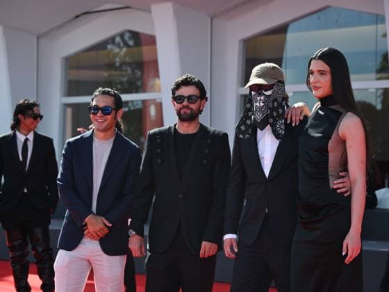 Venice, ITALY: Venice, 82nd Venice International Film Festival 2025 - evening 7 - red carpet of the film L Etranger (The Stranger) In the photo: Eric Kohn, Stillz, Arca and Esteban Zuluaga Venice ITALY  - ZUMAp169 20250902_zea_p169_1127 Copyright: xSimonexComix