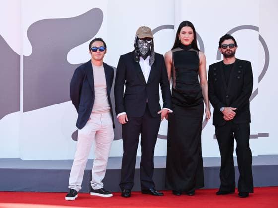 Venice, ITALY: Venice, 82nd Venice International Film Festival 2025 - evening 7 - red carpet of the film L Etranger (The Stranger) In the photo: Eric Kohn, Stillz, Arca and Esteban Zuluaga Venice ITALY  - ZUMAp169 20250902_zea_p169_1132 Copyright: xSimonexComix