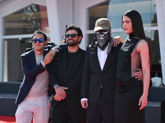 Venice, ITALY: Venice, 82nd Venice International Film Festival 2025 - evening 7 - red carpet of the film L Etranger (The Stranger) In the photo: Eric Kohn, Stillz, Arca and Esteban Zuluaga Venice ITALY  - ZUMAp169 20250902_zea_p169_1140 Copyright: xSimonexComix