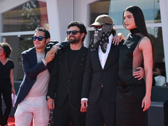 Venice, ITALY: Venice, 82nd Venice International Film Festival 2025 - evening 7 - red carpet of the film L Etranger (The Stranger) In the photo: Eric Kohn, Stillz, Arca and Esteban Zuluaga Venice ITALY  - ZUMAp169 20250902_zea_p169_1149 Copyright: xSimonexComix