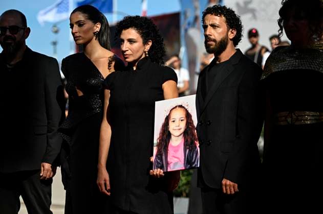 September 3, 2025, Venice, Italy: Clara Khoury (L) and Motaz Malhees (R) hold a picture of Hind Rajab on the red carpet for the premiere of ˜The voice of Hind Rajab™ during the 82nd Venice Film Festival in Venice, Italy, 03 September 2025. The movie is presented in official competition Venezia 82 at the festival running from 28 August to 6 September 2025. ANSA RICCARDO ANTIMIANI. Venice Italy  - ZUMAa110 20250903_zaf_a110_036 Copyright: xRiccardoxAntimianix