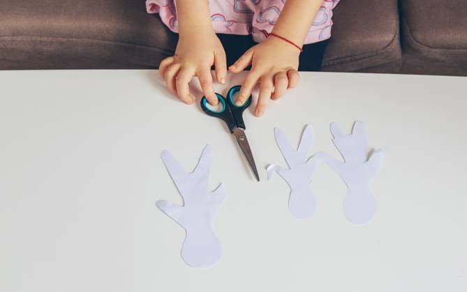 Child holding paper cutout family. Selective focus. Child holding paper cutout family. Selective focus. Kid., model released, , 64925012.jpg RECORD DATE NOT STATED