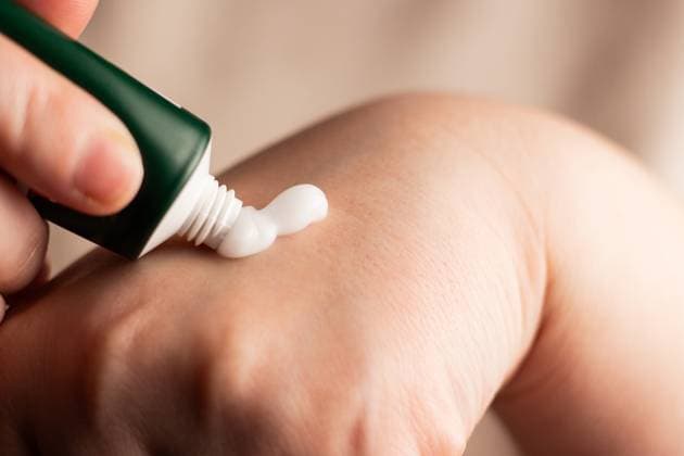 Woman applying hand cream on hands. Close up image of white cream. Squeeze cream out of tube. Soft hands and skincare concept. Woman applying hand cream on hands. Close up image of white cream. Squeeze cream out of tube. Soft hands and skincare concept., 65204166.jpg RECORD DATE NOT STATED