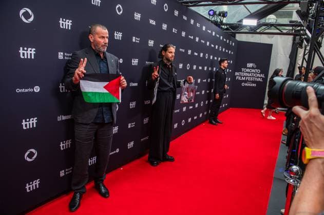 September 5, 2025, Toronto, On, Canada: Saleh Bakri, left, and Karim Daoud Anaya hold up a Palestinian flag and a camera soaked in fake blood on the red carpet for öÄuPalestine 36öÄù at the Toronto International Film Festival in Toronto on Friday, September 5, 2025. Toronto Canada - ZUMAc35_ 20250905_zaf_c35_042 Copyright: xLauraxProctorx