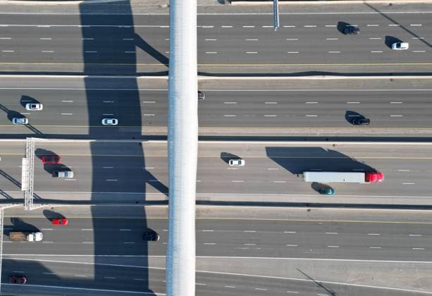 World’s Longest Enclosed Pedestrian Bridge PICKERING, ONTARIO - APRIL 27 : Aerial view of cars and trucks pass under Pickering pedestrian bridge on Highway 401 in Pickering, Ontario on April 27, 2023. Guinness World Record holder Pickering pedestrian bridge, located 45 minutes east of Toronto, in the City of Pickering, Ontario, Canada was completed in September 2018. The 250-meter bridge stretches across 14 lanes of Highway 401, six active railway tracks, and a two-lane local road. Additionally, it features nearly 300 LED lights that illuminate it beautifully at night. Ontario Canada. Editorial use only. Please get in touch for any other usage. Copyright: x2025xAnadoluxMertxAlperxDerviÅüx