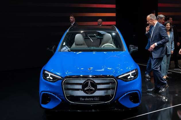 Munich, Bavaria, Germany - September 9, 2025: IAA Mobility 2025 trade fair in Munich. Tour of the trade fair, Friedrich Merz (CDU party Chancellor) walks to a Mercedes-Benz GLC electric SUV at the Mercedes-Benz stand *** IAA Mobility 2025 Messe in München. Messerundgang, Friedrich Merz (Partei CDU Bundeskanzler bzw. Kanzler) läuft am Messestand von Mercedes-Benz zu einem Mercedes-Benz Elektro SUV GLC