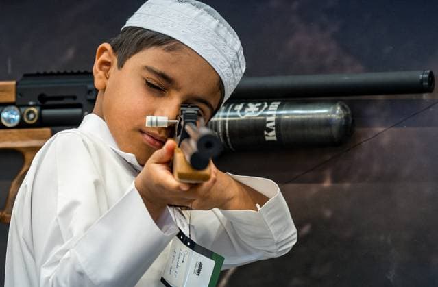 KATARA INTERNATIONAL HUNTING AND FALCONS EXHIBITION 2025 A young Qatari boy check a hunting rifle in the guns section at the Katara International Hunting and Falcons Exhibition 2024 (S hail) at Katara Cultural Village in Doha, Qatar, on September 10, 2025. The event is held here from Sept. 10 to 14. DOHA Qatar Copyright: xNOUSHADx