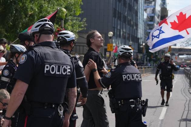 September 10, 2025, Toronto, On, Canada: Police detain a protester outside of Roy Thomson Hall during the screening of the documentary The Road Between Us: The Ultimate Rescue at the Toronto International Film Festival in Toronto on Wednesday, Sept. 10, 2025. Toronto Canada  - ZUMAc35_ 20250910_zaf_c35_059 Copyright: xChrisxYoungx