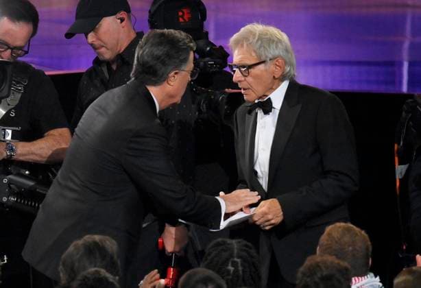 Stephen Colbert speaks to Harrison Ford at the 77th annual Primetime Emmy Awards at the Peacock Theater in Los Angeles on Sunday, September 14, 2025.  LAP202509142001 JIMxRUYMEN