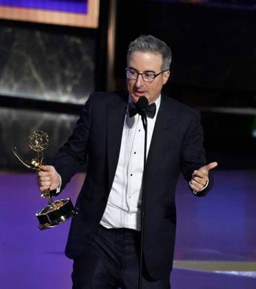 John Oliver (C) accepts the Outstanding Scripted Variety Series award for Last Week Tonight with John Oliver onstage at the 77th annual Primetime Emmy Awards at the Peacock Theater in Los Angeles on Sunday, September 14, 2025.  LAP2025091480486 JIMxRUYMEN