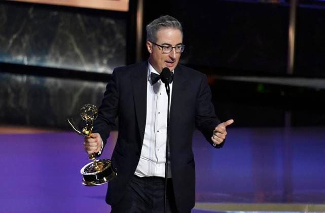 John Oliver (C) accepts the Outstanding Scripted Variety Series award for Last Week Tonight with John Oliver onstage at the 77th annual Primetime Emmy Awards at the Peacock Theater in Los Angeles on Sunday, September 14, 2025.  LAP2025091480487 JIMxRUYMEN