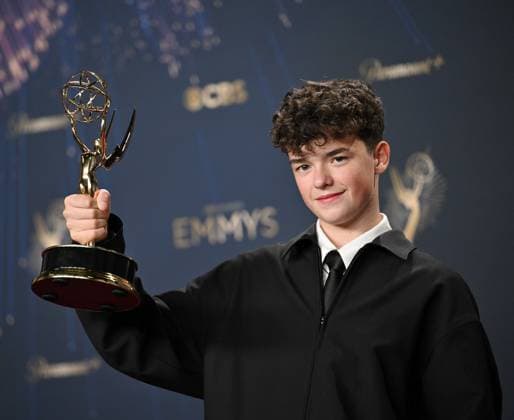 Owen Cooper holds the Emmy for Outstanding Supporting Actor in a Limited or Anthology Series or Movie for Adolescence, backstage during the 77th annual Primetime Emmy Awards at the Peacock Theater in Los Angeles on Sunday, September 14, 2025.  LAP20250914184 CHISxCHEW