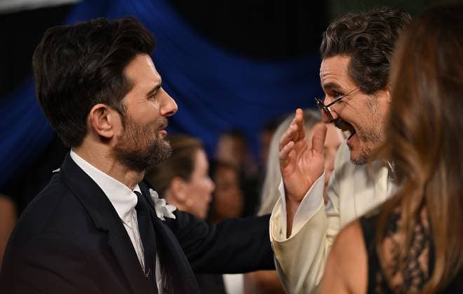 (L-R): Adam Scott and Pedro Pascal arrive for the 77th annual Primetime Emmy Awards at the Peacock Theater in Los Angeles on Sunday, September 14, 2025.  LAP20250914235 CHISxCHEW