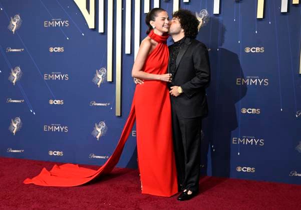 Selena Gomez gets a kiss from Benny Blanco as they arrive for the 77th annual Primetime Emmy Awards at the Peacock Theater in Los Angeles on Sunday, September 14, 2025.  LAP202509142229 JohnxMcCoy