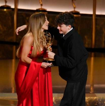 Sydney Sweeney presents the Outstanding Supporting Actor in a Limited or Anthology Series or Movie award for Adolescence to Owen Cooper onstage during at the 77th annual Primetime Emmy Awards at the Peacock Theater in Los Angeles on Sunday, September 14, 2025.  LAP20250914900 JIMxRUYMEN