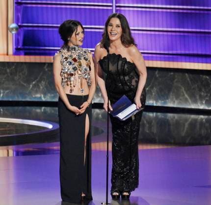 Jenna Ortega (L) and Catherine Zeta-Jones appear onstage at the 77th annual Primetime Emmy Awards at the Peacock Theater in Los Angeles on Sunday, September 14, 2025.  LAP20250914918 JIMxRUYMEN