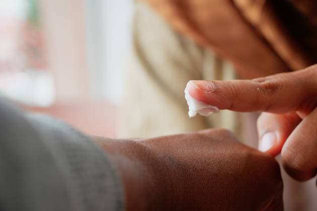 Applying moisturizer to skin during a skincare routine A person applies cream to another s arm for hydration and care., 95010136.jpg RECORD DATE NOT STATED