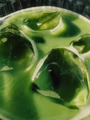 Iced Matcha Latte with Ice Cubes Melting in Glass. Close up of refreshing iced matcha latte, showcasing vibrant green color and melting ice cubes in glass, creating visually appealing summer beverage Iced Matcha Latte with Ice Cubes Melting in Glass. Close up of refreshing iced matcha latte, showcasing vibrant green color and melting ice cubes in glass, creating visually appealing summer beverage, 94974572.jpg RECORD DATE NOT STATED