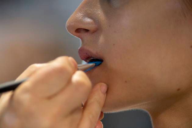 September 18, 2025, Madrid, Madrid, Spain: A makeup artist paints a model s lips blue backstage during the Agatha Ruiz de la Prada Spring Summer 2026 show at the 40th Mercedes-Benz Fashion Week in Madrid. Madrid Spain - ZUMAs296 20250918_znp_s296_008 Copyright: xLuisxSotox