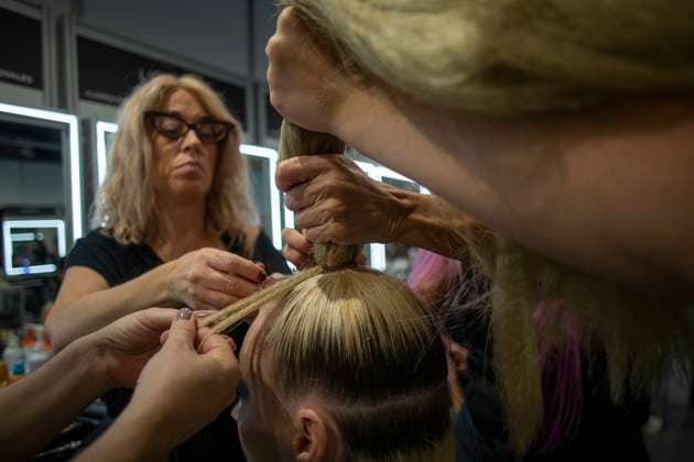 September 18, 2025, Madrid, Madrid, Spain: Stylists style a model s hair backstage during the Agatha Ruiz de la Prada Spring Summer 2026 collection runway show at the 40th Mercedes-Benz Fashion Week in Madrid. Madrid Spain - ZUMAs296 20250918_znp_s296_009 Copyright: xLuisxSotox