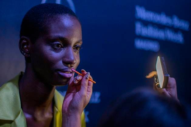 September 20, 2025, Madrid, Madrid, Spain: A makeup artist touches up a model s lips during during the Fely Campo Spring Summer 2026 collection runway show during the 40th Mercedes-Benz Fashion Week in Madrid. Madrid Spain - ZUMAs296 20250920_znp_s296_002 Copyright: xLuisxSotox