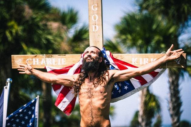 September 21, 2025, Dunedin, Florida, USA: TERRY TURNBLOM positions himslef on a cross for others to view in the wake of the death of CHARLIE KIRK as supporters waves flags and give speeches to memorialize his life. Dunedin USA - ZUMAd256 20250921_znp_d256_038 Copyright: xDavexDeckerx