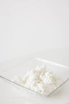 Fresh cottage cheese in glass bowl on white background for cookbook Prague, Prague, Czechia R_UZFO250918-1834607-01