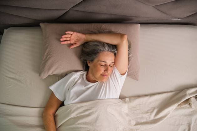Person sleeping comfortably in bed during morning routine model released, Symbolfoto property released, CVMF00200