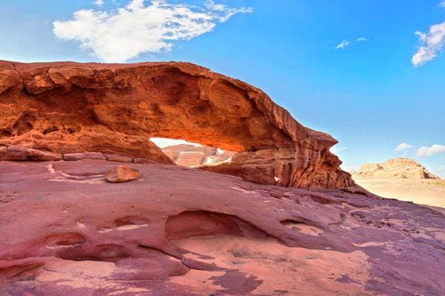 Creative Highlights World Little arc or small rock window formation in Wadi Rum desert, bright sun shines on red dust and rocks, blue sky above Little arc or small rock window formation in Wadi Rum desert, bright sun shines on red dust and rocks, blue sky above, 95433806.jpg RECORD DATE NOT STATED