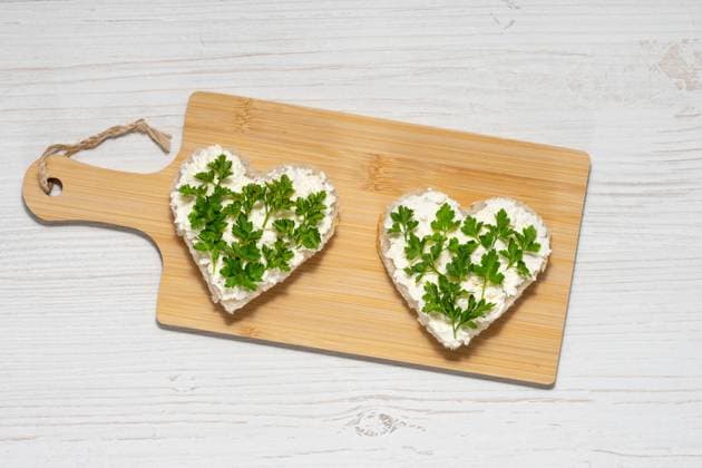 Two heart-shaped sandwiches with cottage cheese and parsley Two heart-shaped sandwiches with cottage cheese and parsley., 59342376.jpg RECORD DATE NOT STATED