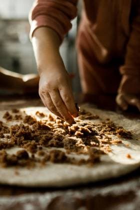 Child Sprinkling Brown Sugar on Dough in Kitchen Calgary, Alberta, Canada CR_AMST250930-1776699-01 ,model released, Symbolfoto ,property released