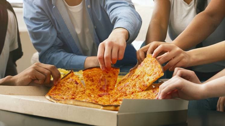 Group of Friends Sharing Large Pepperoni Pizza at Casual Gathering Cropped of group of friends are gathered around a table, eagerly reaching out to grab slices of a large pepperoni pizza from an open cardboard box during a casual social event, model released, , 59778262.jpg RECORD DATE NOT STATED