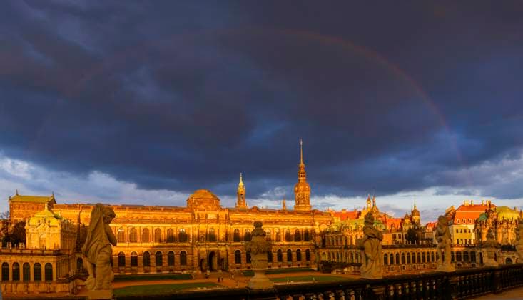 Old Town Zwinger in the evening light in front of dark sky with rainbow Dresden Saxony Germany