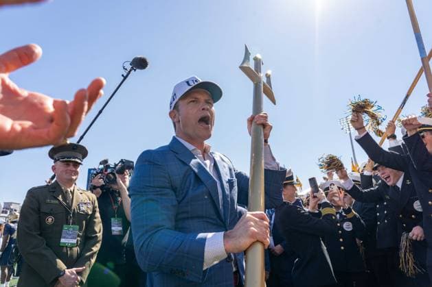 October 4, 2025, Annapolis, Maryland, USA: Secretary of War PETE HEGSETH cheers as he raises a trident into the sky while nearby Midshipmen wave pompoms at the Navy vs. Air Force football game. Annapolis USA - ZUMAs365 20251004_znp_s365_011 Copyright: xJoeyxSussmanx