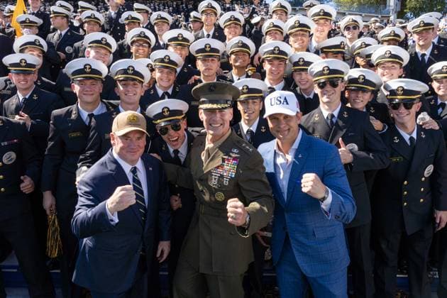 October 4, 2025, Annapolis, Maryland, USA: Secretary of War PETE HEGSETH, United States Naval Academy Superintendent Marine Corps Lieutenant General MICHAEL J. BORGSCHULTE, and Secretary of the Navy JOHN PHELAN raise their fists to pose for a photo with a group of Midshipmen at the Navy vs. Air Force football game. Annapolis USA - ZUMAs365 20251004_znp_s365_013 Copyright: xJoeyxSussmanx