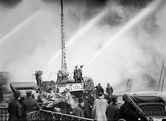 fire fighters, emergency workers, occupations, New York City, historical, May 2, 2022, New York City, New York, USA: Fireman spraying water on burning building, 14th Street, New York City, New York, USA, Bain News Service, December 1909 Copyright: xJTxVintagex