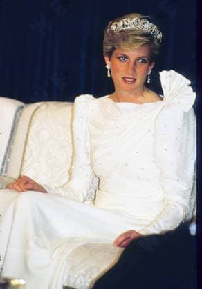 ***File Photo*** The designers behind Princess Diana s wedding dress are putting a host of iconic outfits belonging to the late royal under the hammer. David and Elizabeth Emanuel designed the fairytale princess gown Diana wore to marry Prince Charles in 1981, and helped the shy nursery school teacher become the most glamorous and beloved member of British royal family. Included in the sale is the black taffeta Emanuel dress worn by Diana on her first appearance as the Prince of Wales fiance, as well as original sketches of her wedding dress and the chiffon blouse Diana wore for her engagement portrait by Lord Snowdon. The lots will be open to bidders in London on 8 June (10). London, England - 13.04.10 Diana, Princess of Wales wears a si Anwar Hussein WENN 5459215.jpg