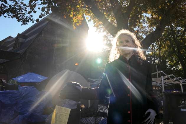 October 16, 2025, Toronto, On, Canada: Rev. Canon Maggie Helwig stands amid structures as Toronto city workers prepare to clear the unhoused persons encampment at St. Stephen-in-the-Fields Church, in Toronto, on Thursday, Oct. 16, 2025. Toronto Canada  - ZUMAc35_ 20251016_zaf_c35_013 Copyright: xChrisxYoungx