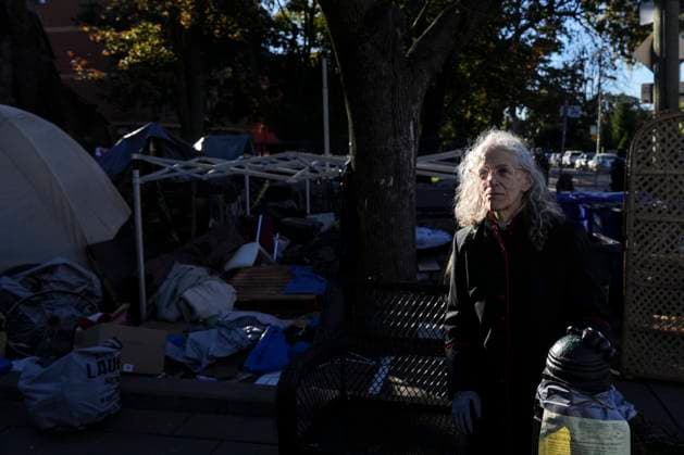 October 16, 2025, Toronto, On, Canada: Rev. Canon Maggie Helwig stands amid structures as Toronto city workers prepare to clear the unhoused persons encampment at St. Stephen-in-the-Fields Church, in Toronto, on Thursday, Oct. 16, 2025. Toronto Canada  - ZUMAc35_ 20251016_zaf_c35_016 Copyright: xChrisxYoungx