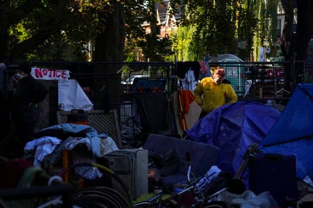 October 16, 2025, Toronto, On, Canada: An encampment resident stands among structures as Toronto city workers prepare to clear the unhoused persons encampment at St. Stephen-in-the-Fields Church, in Toronto, on Thursday, Oct. 16, 2025. Toronto Canada  - ZUMAc35_ 20251016_zaf_c35_019 Copyright: xChrisxYoungx