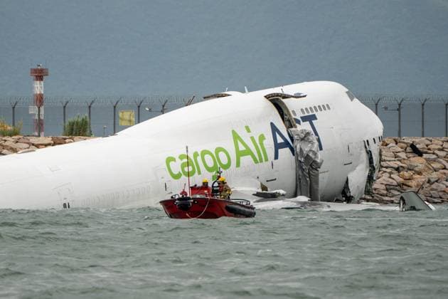 Hong Kong Plane Crash A fire service boat near the wreak of a cargo plane partially in the sea after veering off the runway while landing at Hong Kong International Airport on October 19, 2025 in Hong Kong. Two people were killed after a cargo plane slid off the north runway of Hong Kong International Airport early on Monday morning. (Photo by Vernon Yuen Nexpher Images)