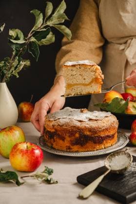 Apple cake being sliced and served in a rustic home setting model released, Symbolfoto property released, IGEF00117